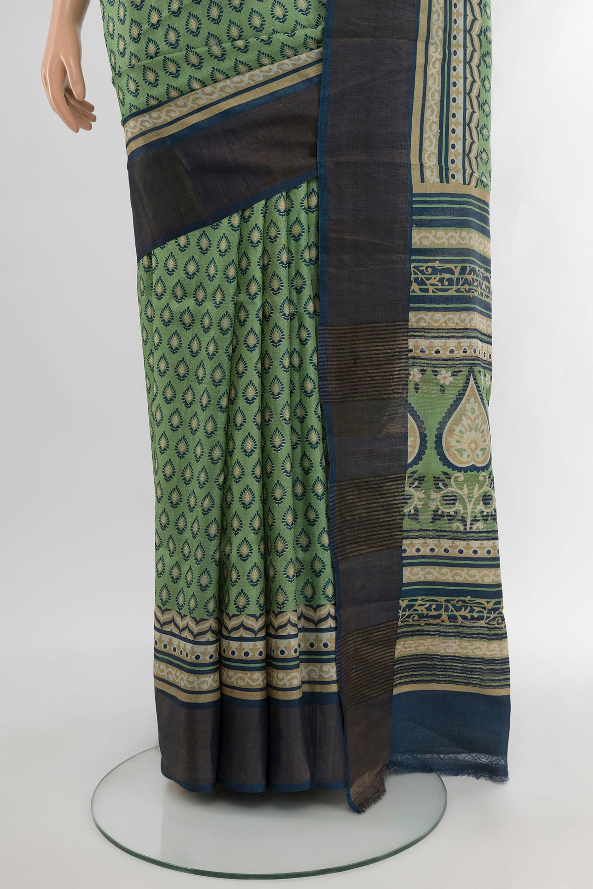 Pleats and pallu of Sage Green Tussar Silk Saree with Floral Print on the body and Zari Border. 
