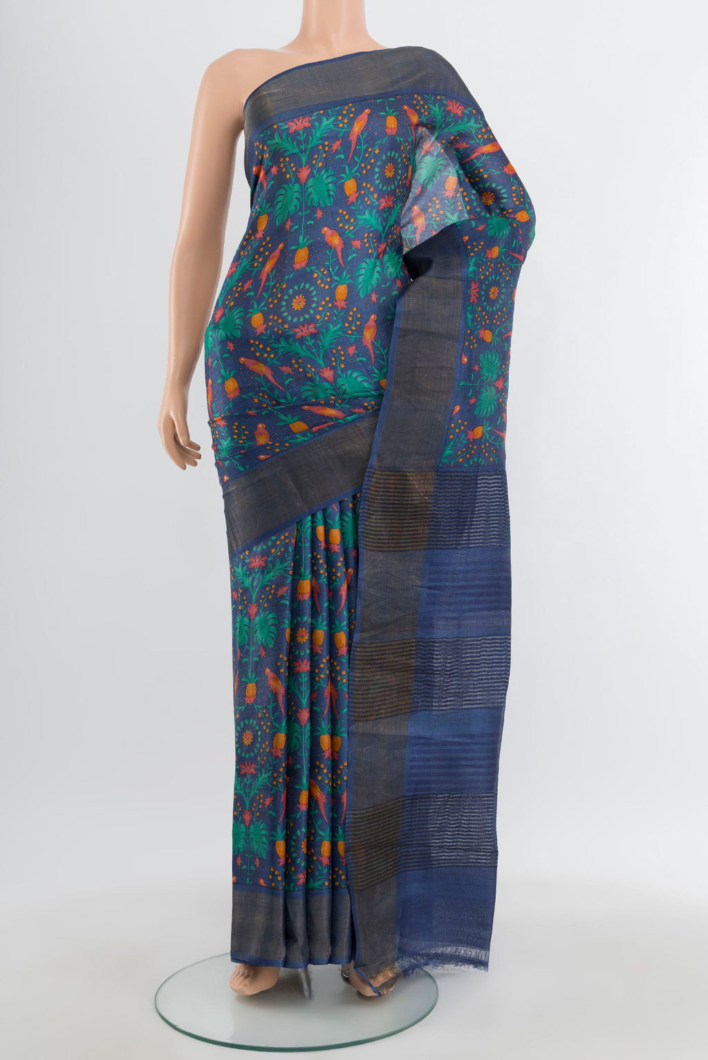 Blue Tussar Silk Saree with Floral Print on the body and Zari Border.  displayed on a mannequin
