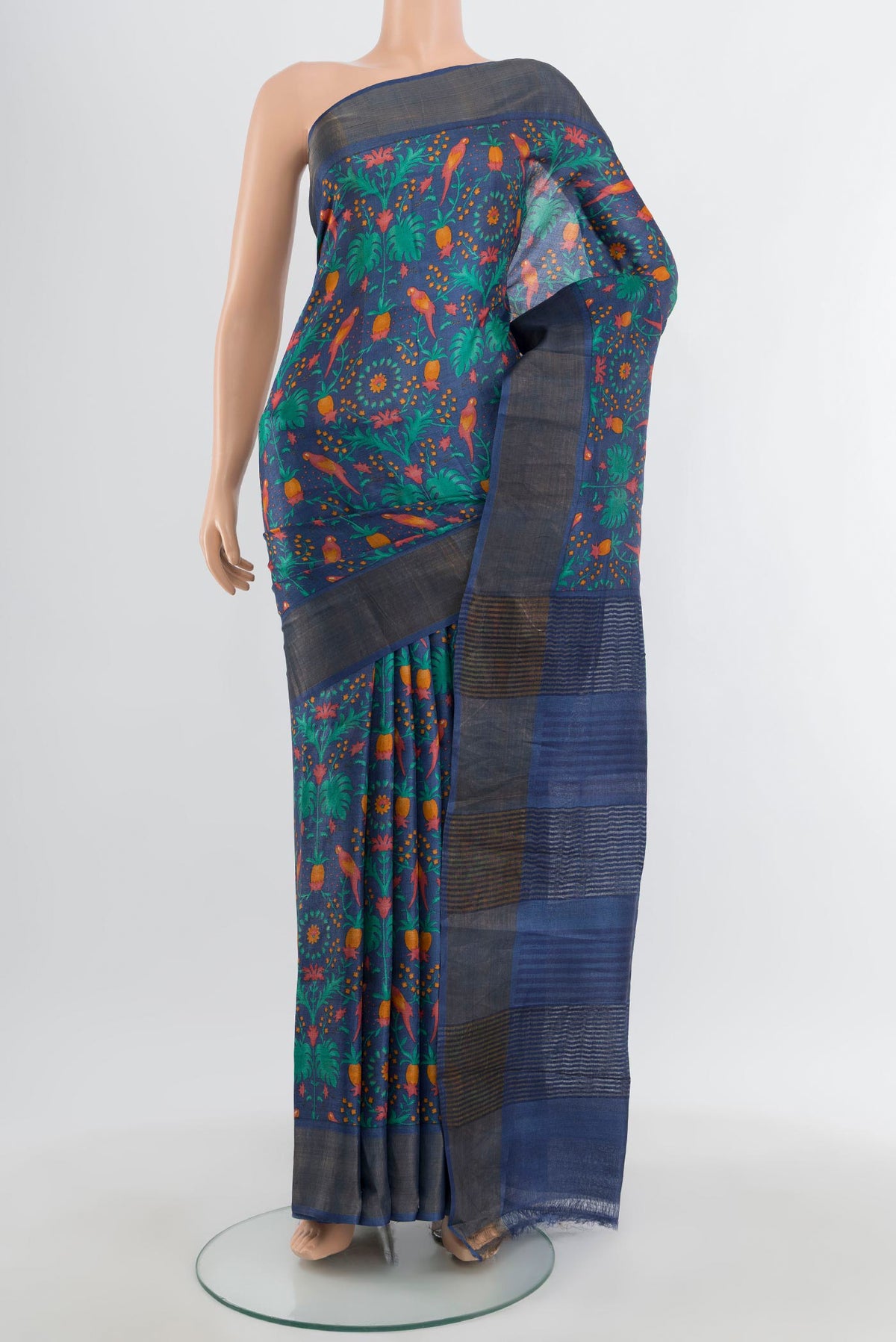 Blue Tussar Silk Saree with Floral Print on the body and Zari Border.  displayed on a mannequin