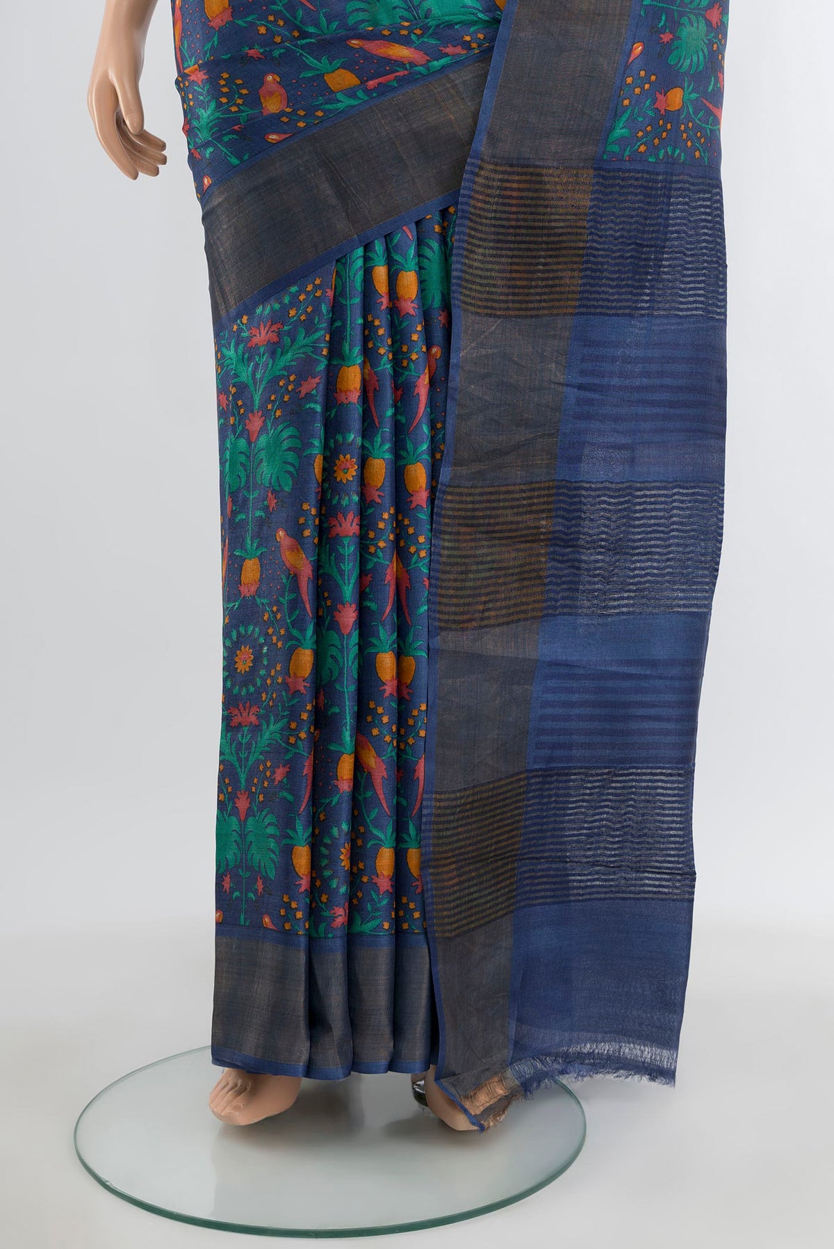 Pleats and pallu of Blue Tussar Silk Saree with Floral Print on the body and Zari Border. 