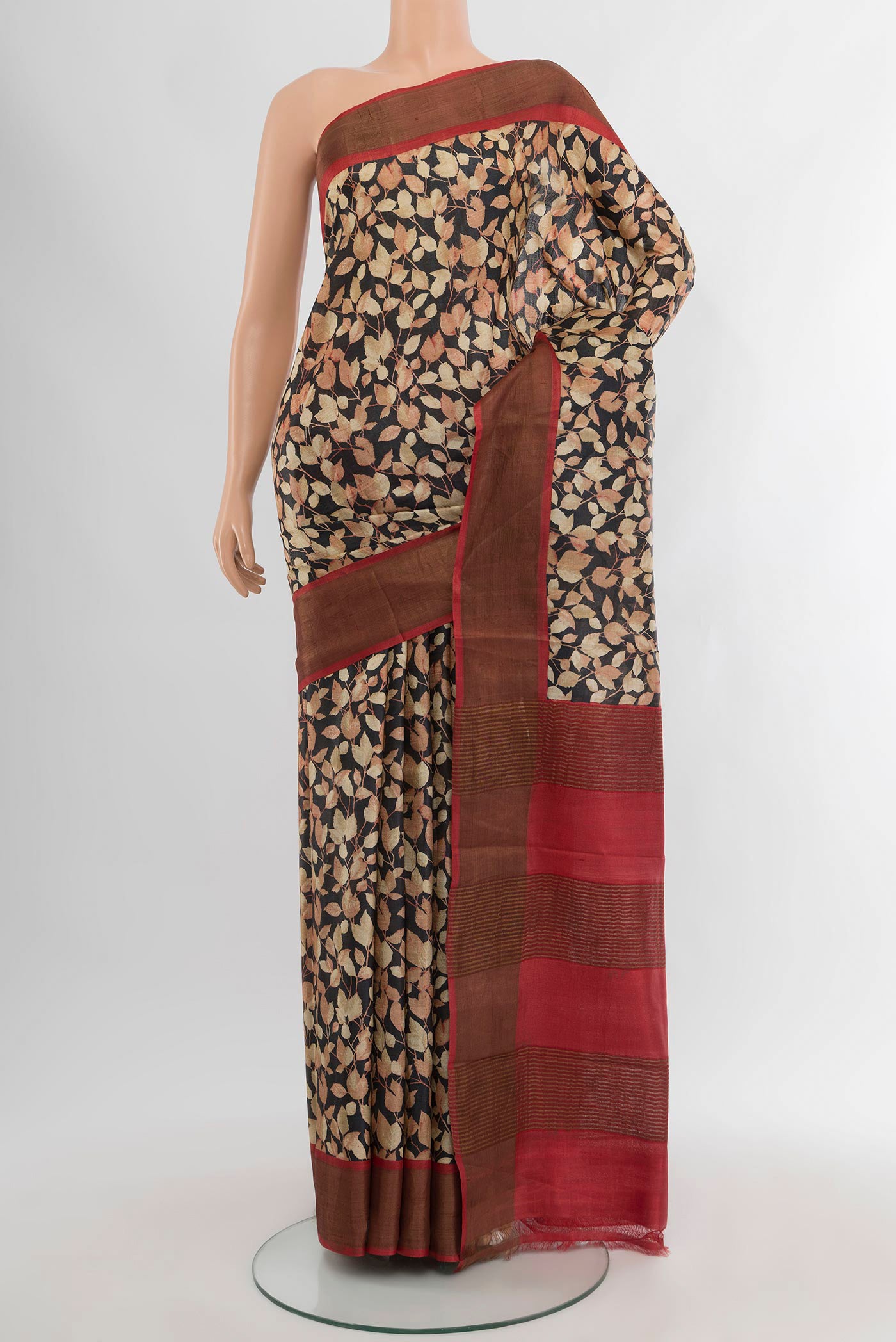 Black Tussar Silk Saree with Floral Print on the body and Zari Border.  displayed on a mannequin