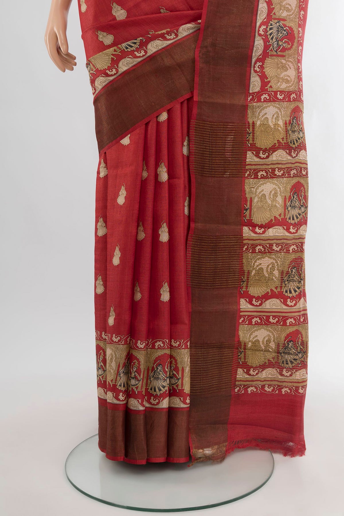 Pleats and pallu of Red Tussar Silk Saree with Floral Print on the body and Zari Border. 