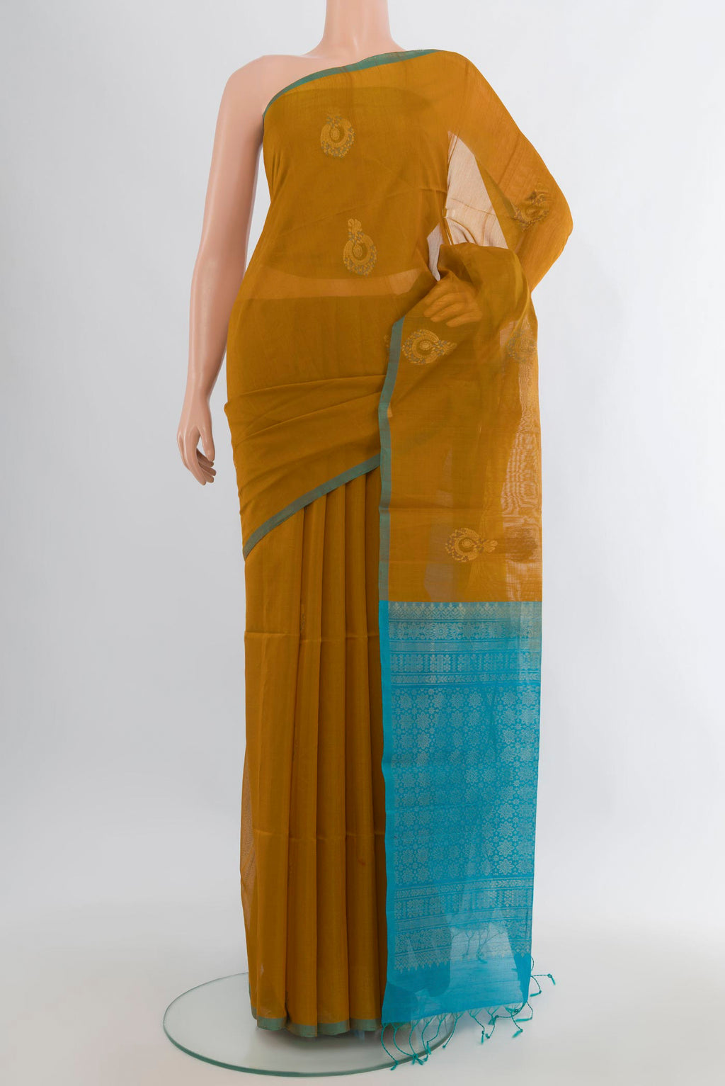 Mustard Silk Cotton Saree with Zari Butta on the body and Without Border.  displayed on a mannequin