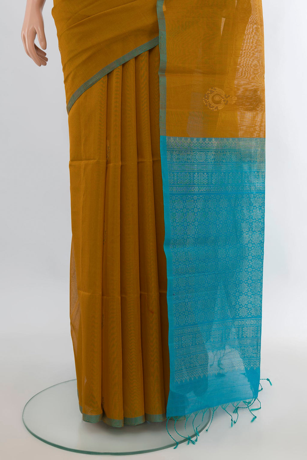 Pleats and pallu of Mustard Silk Cotton Saree with Zari Butta on the body and Without Border. 