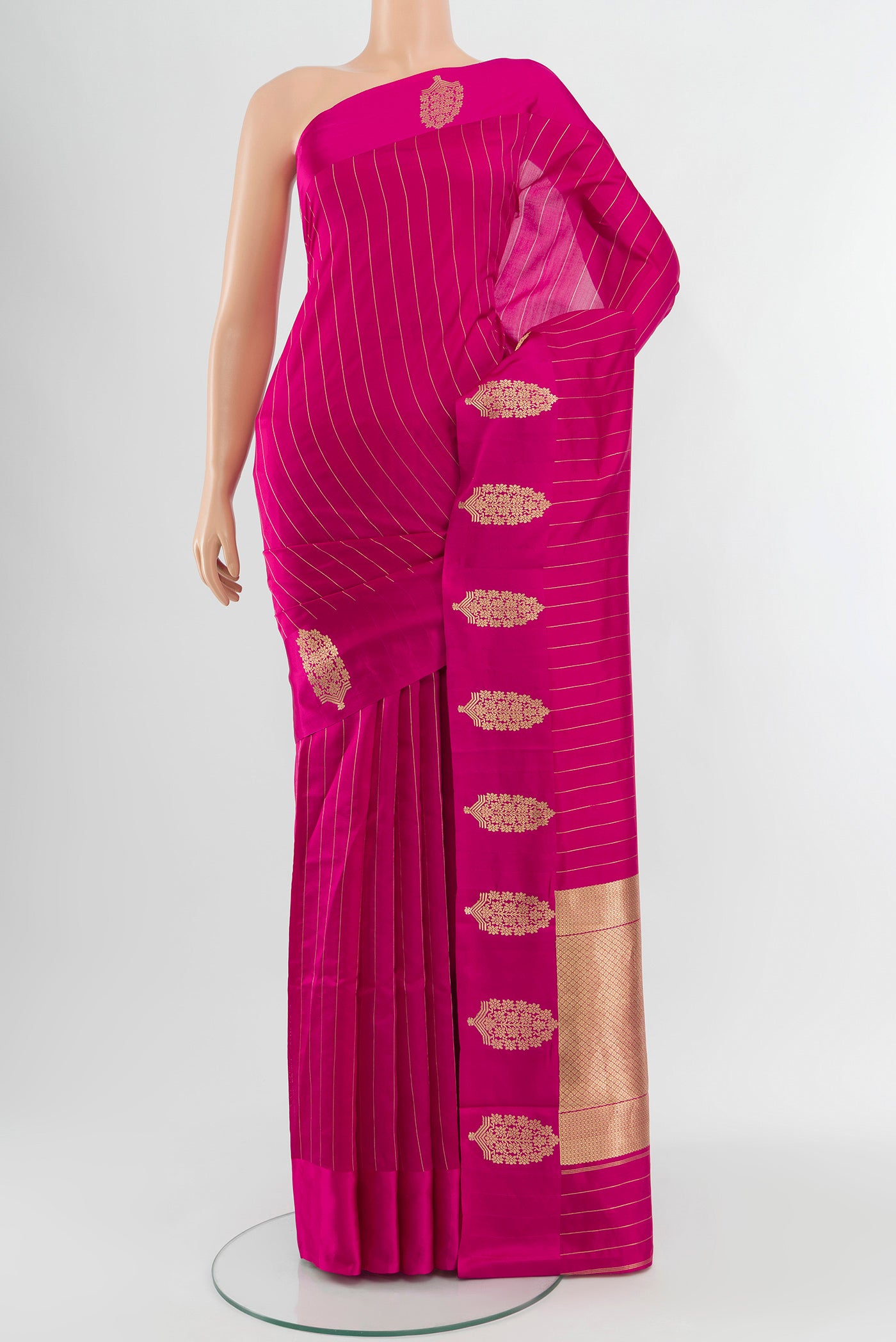 Rani Pink Banarasi Katan Silk Saree with Stripes on the body and Satin Border.  displayed on a mannequin