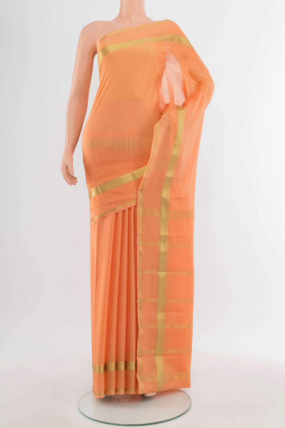 Peach Mysore Crepe Saree with Plain Body and Silk Border.  displayed on a mannequin