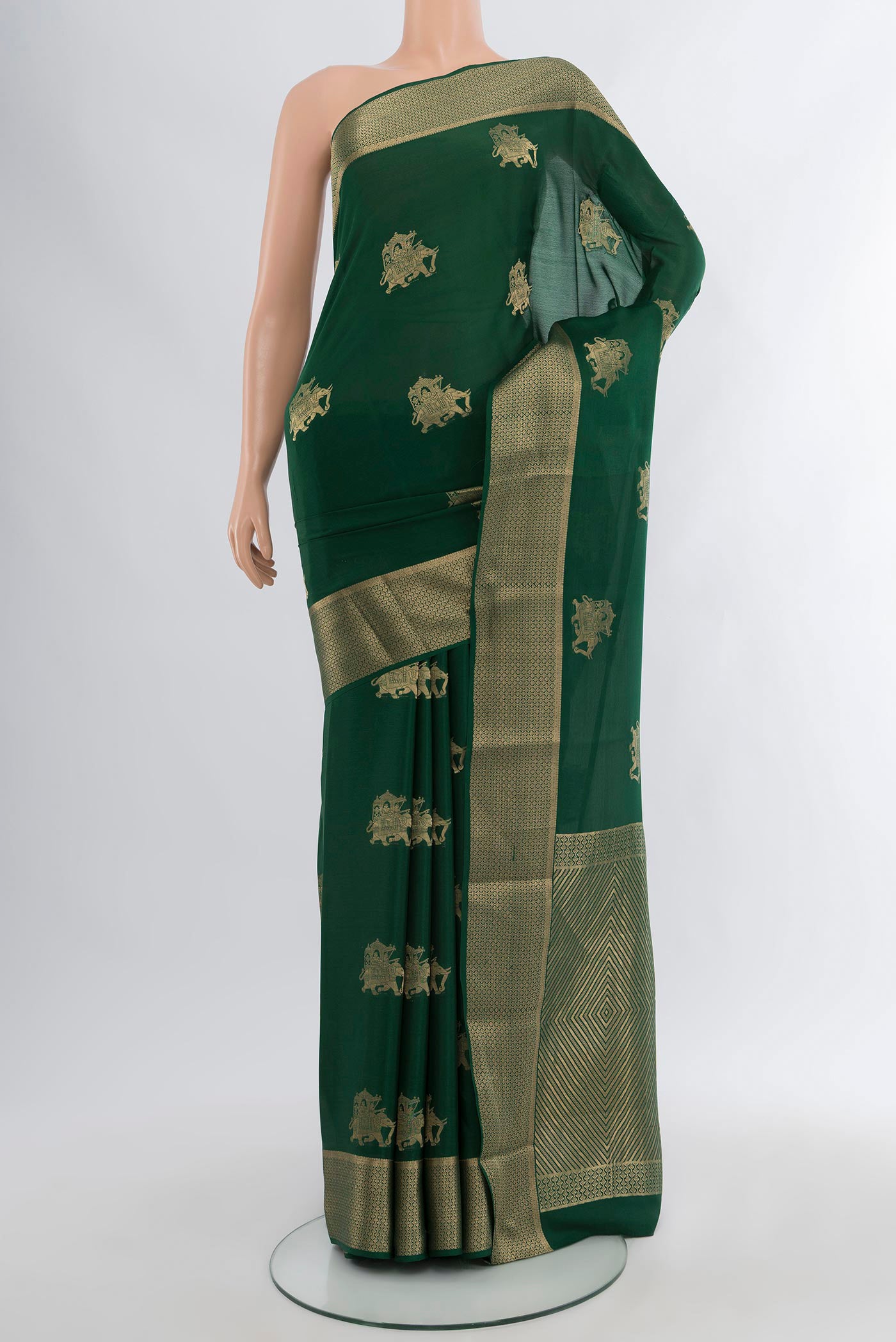 Bottle Green Mysore Crepe Saree with Zari Butta on the body and Zari Border.  displayed on a mannequin