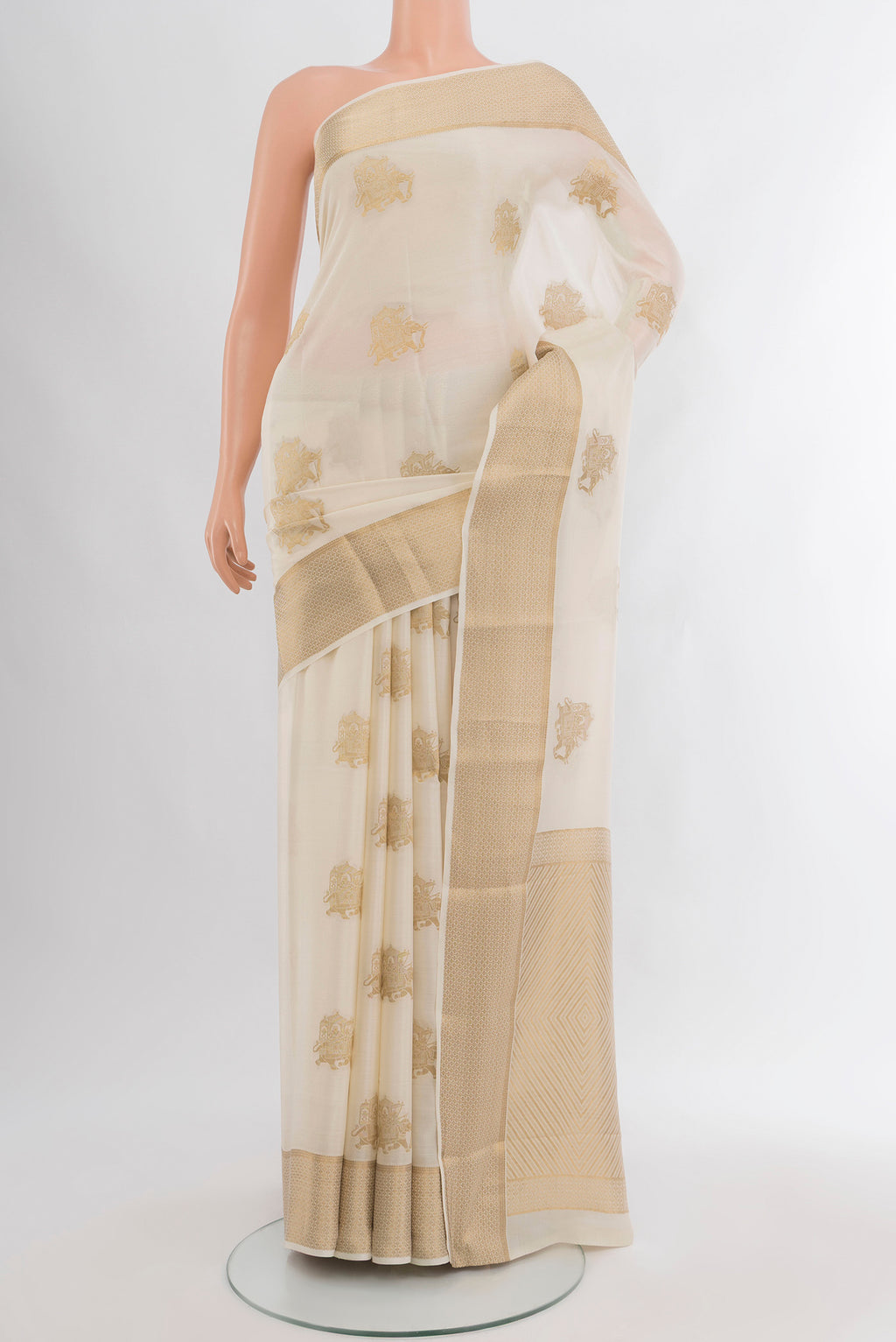 Off White Mysore Crepe Saree with Zari Butta on the body and Zari Border.  displayed on a mannequin