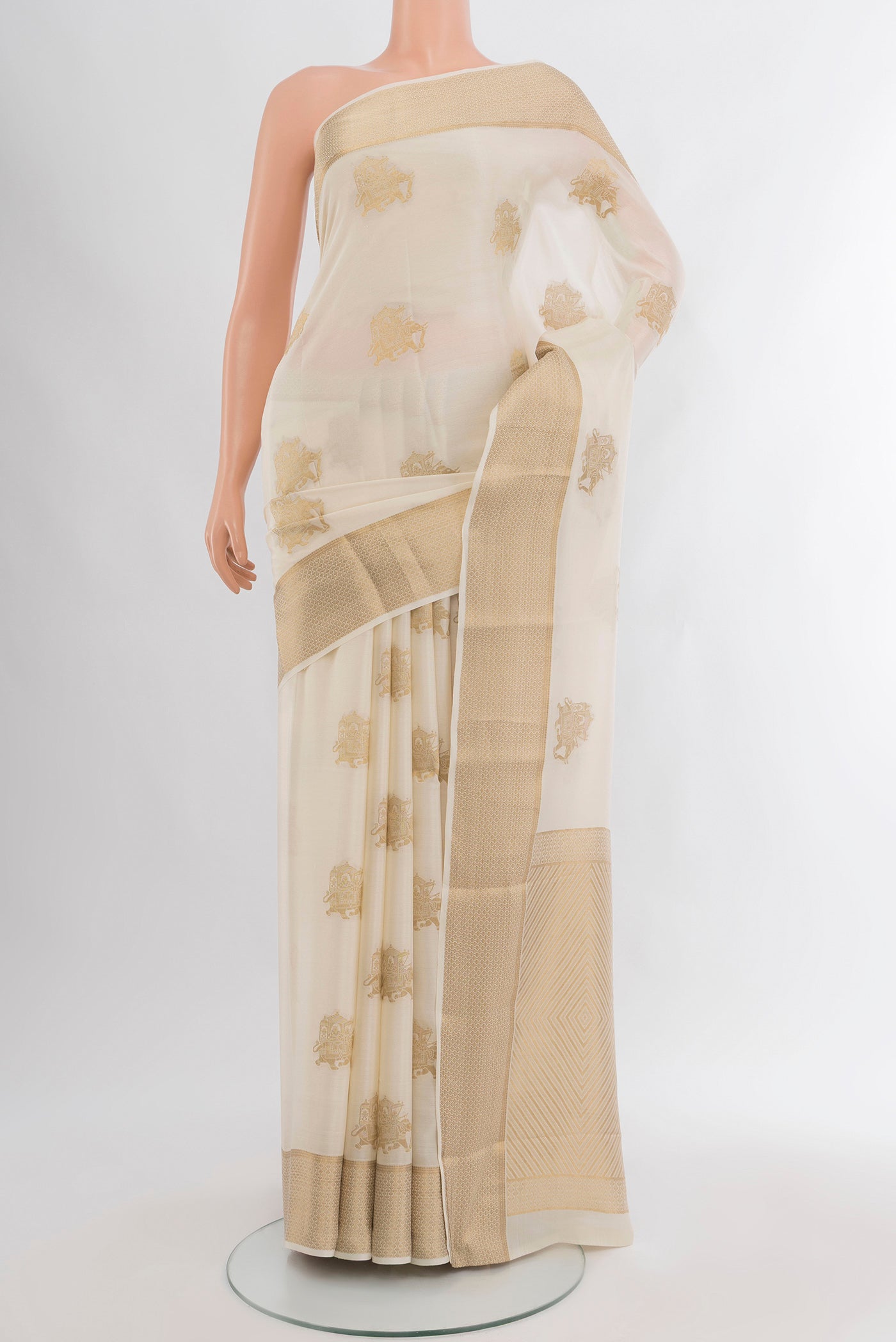 Off White Mysore Crepe Saree with Zari Butta on the body and Zari Border.  displayed on a mannequin