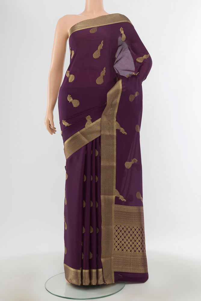 Pure Silk Pure Zari Violet Mysore Crepe Saree with Zari Butta on the body and Silk Border.  displayed on a mannequin