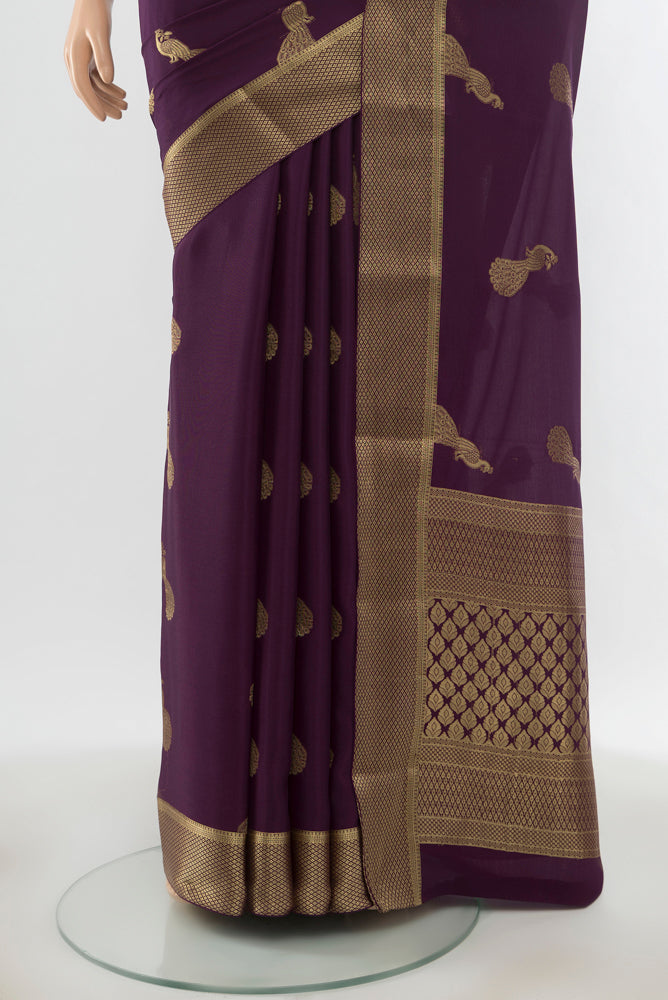Pleats and pallu of Pure Silk Pure Zari Violet Mysore Crepe Saree with Zari Butta on the body and Silk Border. 