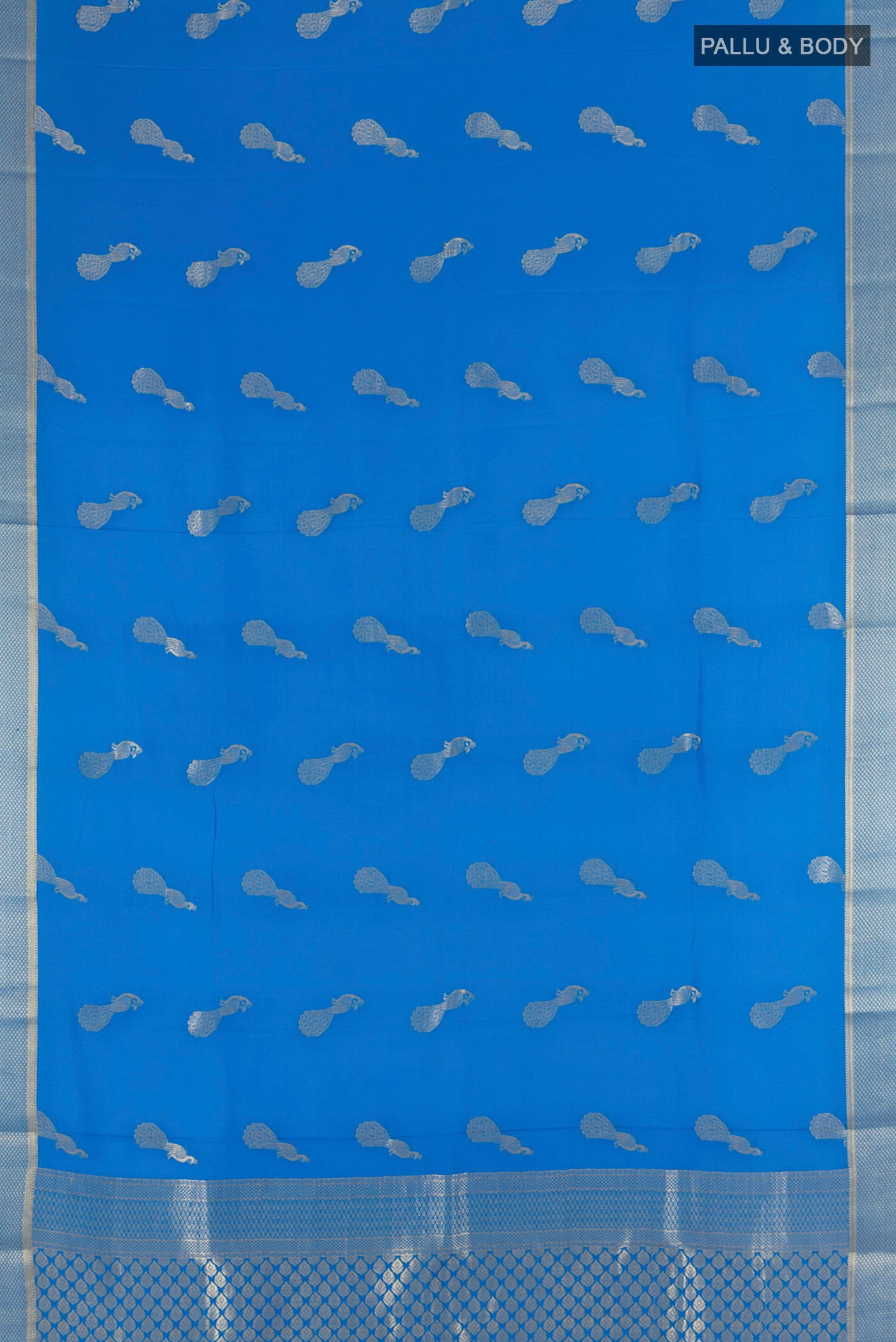 Flat view of Light Blue Mysore Crepe Saree with Zari Butta on the body and Zari Border. 