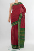 Maroon Pochampally Silk Saree with Plain Body and Ikat Border.  displayed on a mannequin