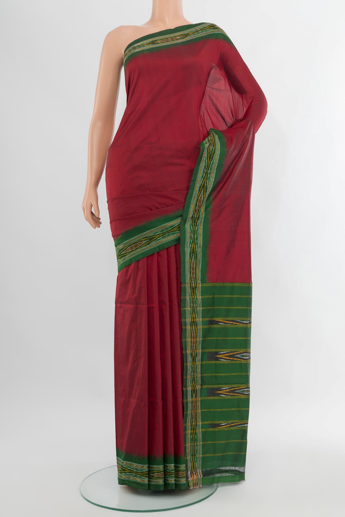 Maroon Pochampally Silk Saree with Plain Body and Ikat Border.  displayed on a mannequin