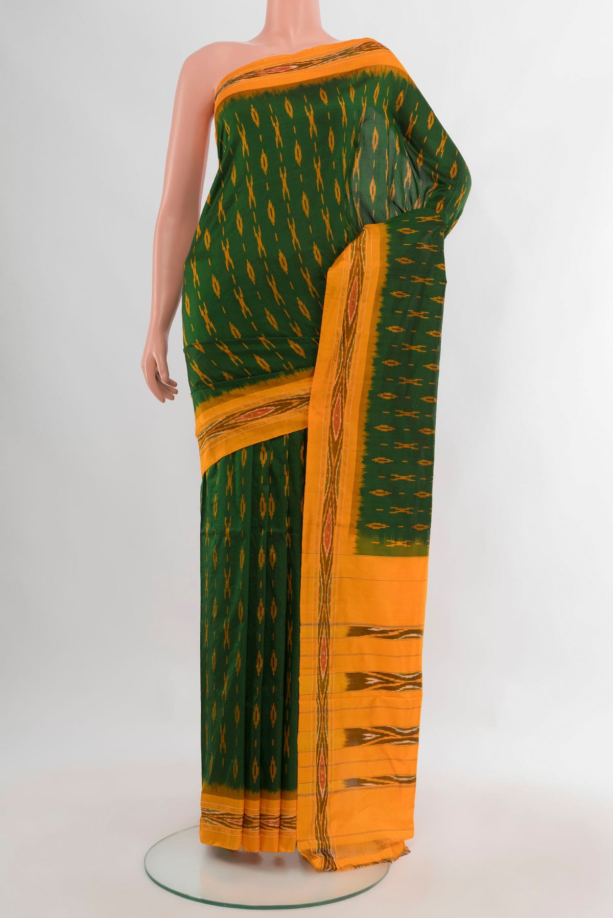Pure Silk Bottle Green Pochampally Saree with Ikat Print on the body and Ikat Border.  displayed on a mannequin