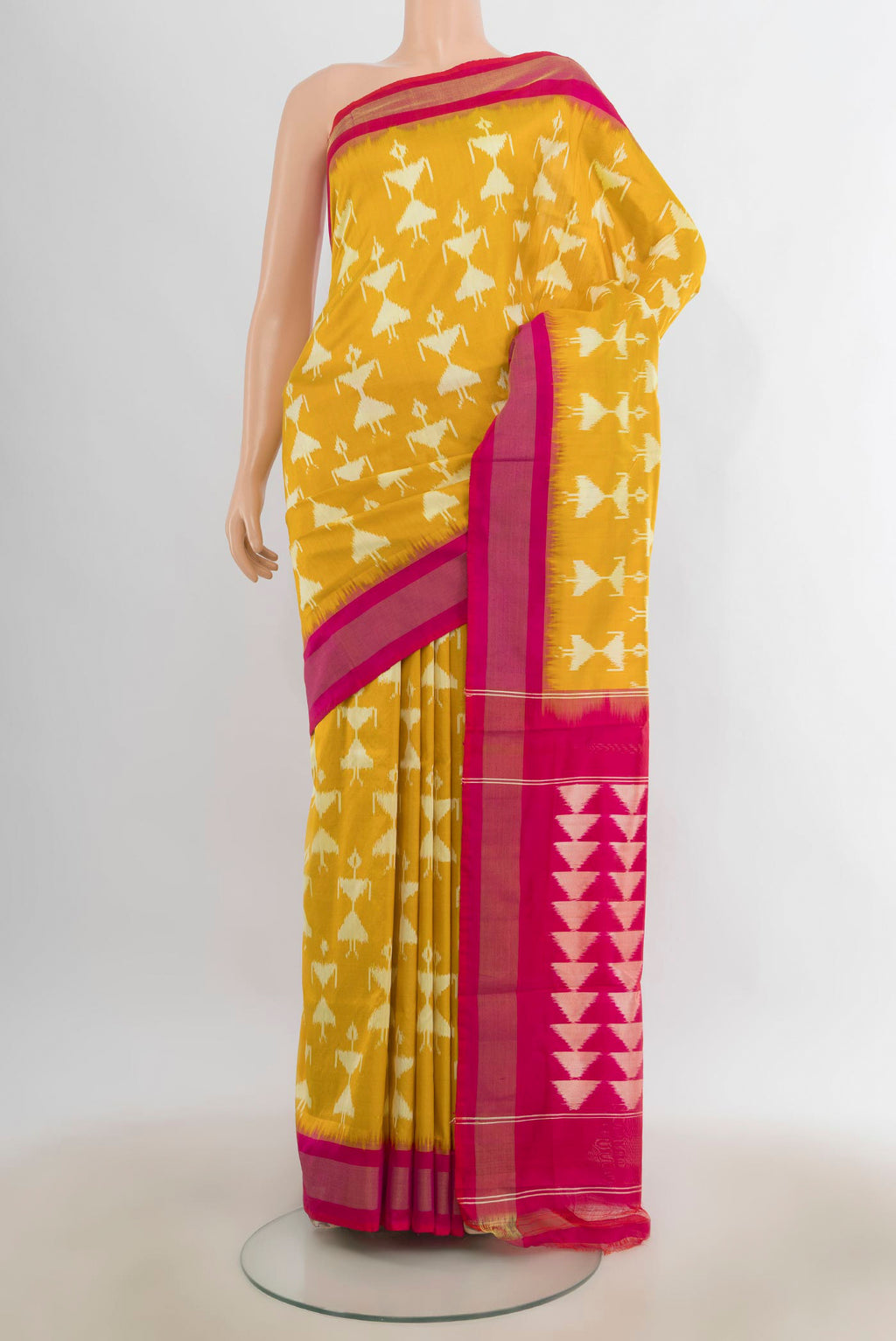 Pure Silk Yellow Pochampally Saree with Ikat design on the body and Zari Border.  displayed on a mannequin