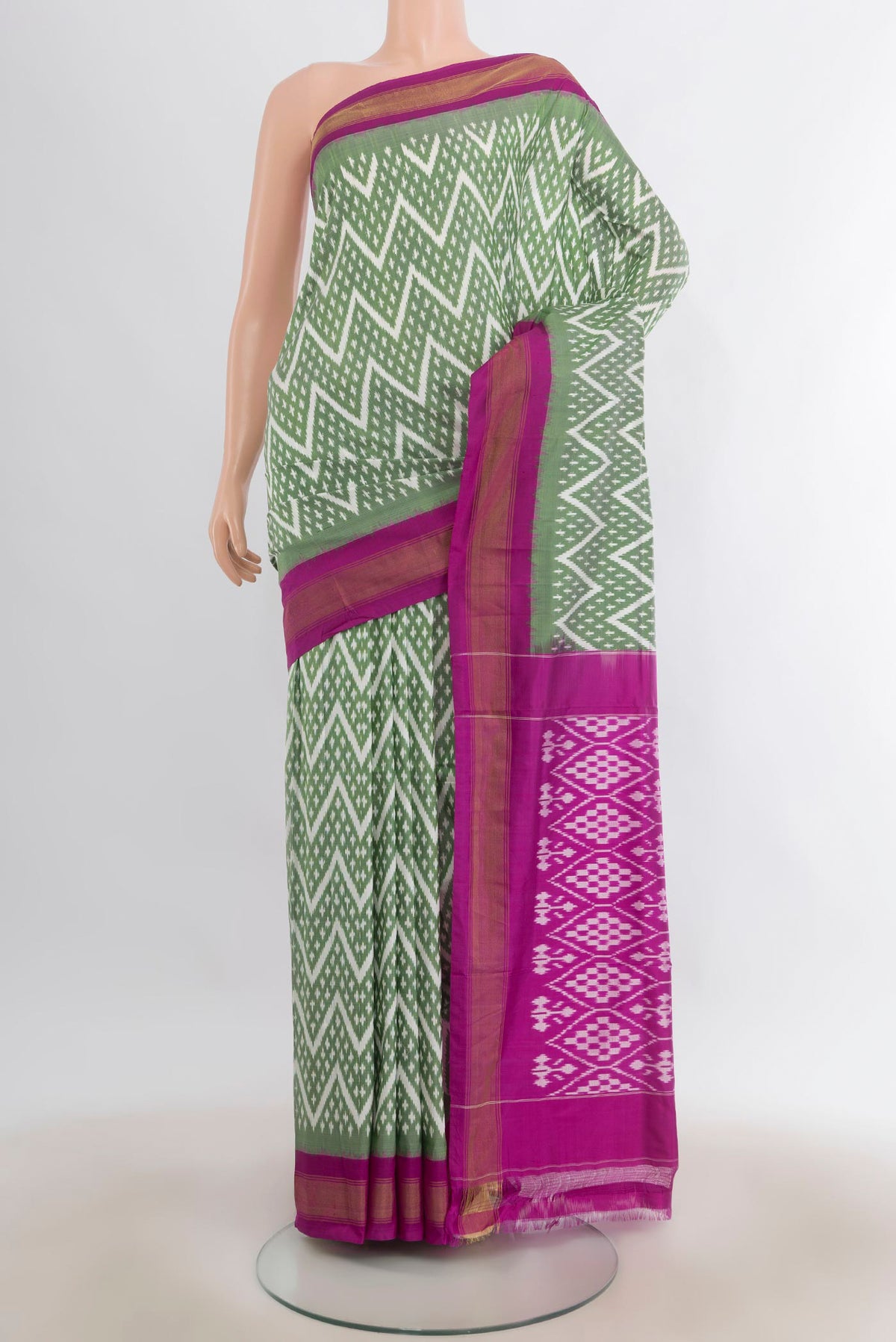 Pure Silk Light Green Pochampally Saree with Pure Ikat on the body and Zari Border.  displayed on a mannequin