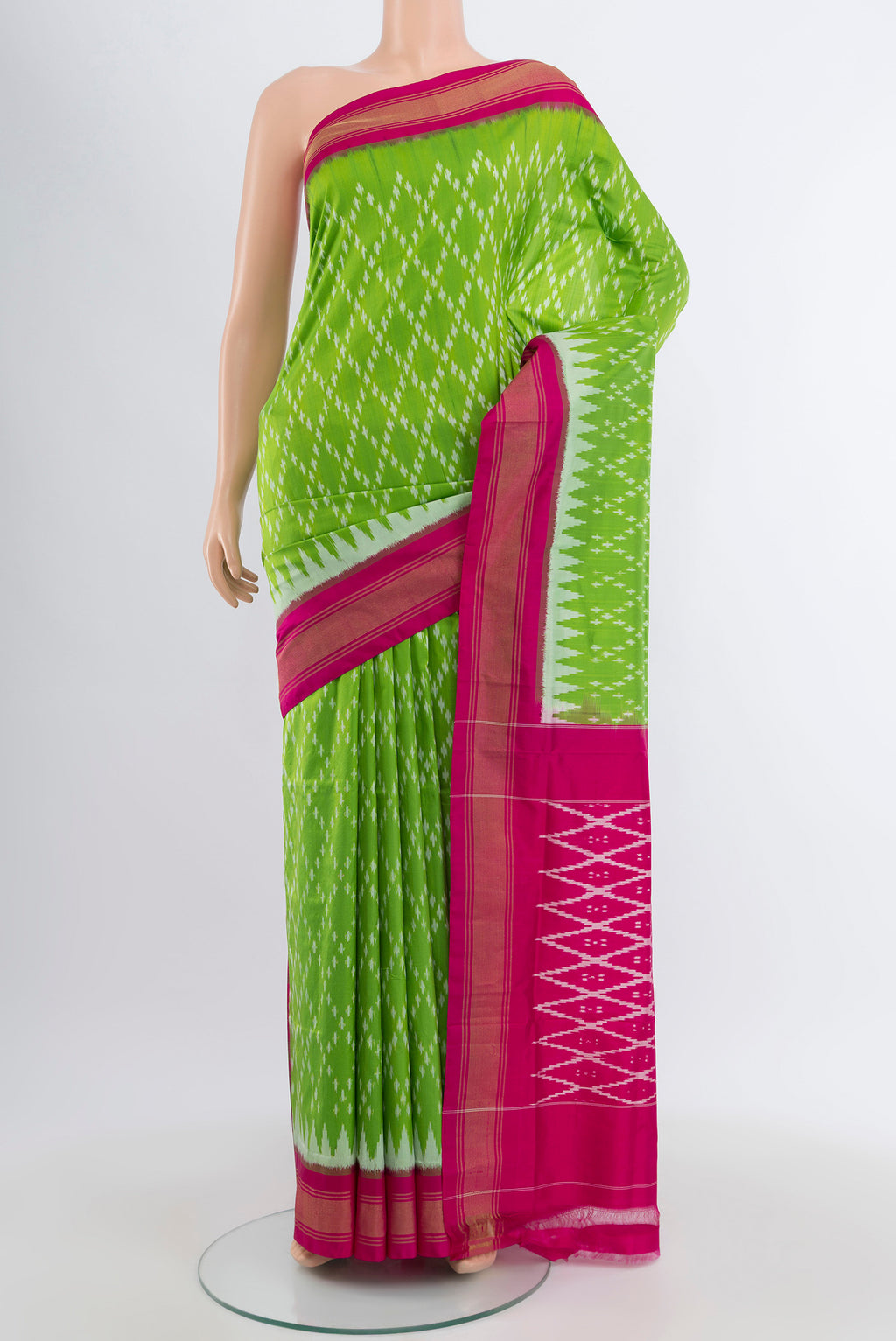 Parrot Green Pochampally Silk Saree with Pure Ikat on the body and Zari Border.  displayed on a mannequin