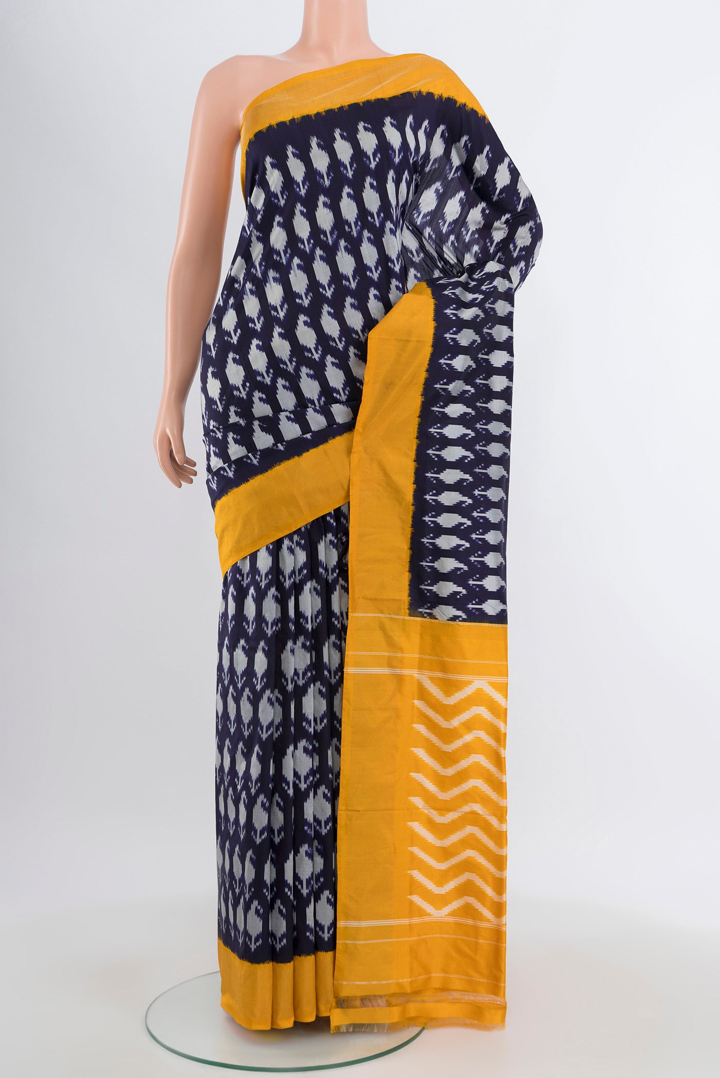 Navy Blue Pochampally Silk Saree with Pure Ikat on the body and Plain Border.  displayed on a mannequin