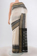 Cream Pochampally Saree with Ikat Print on the body and Silk Border.  displayed on a mannequin