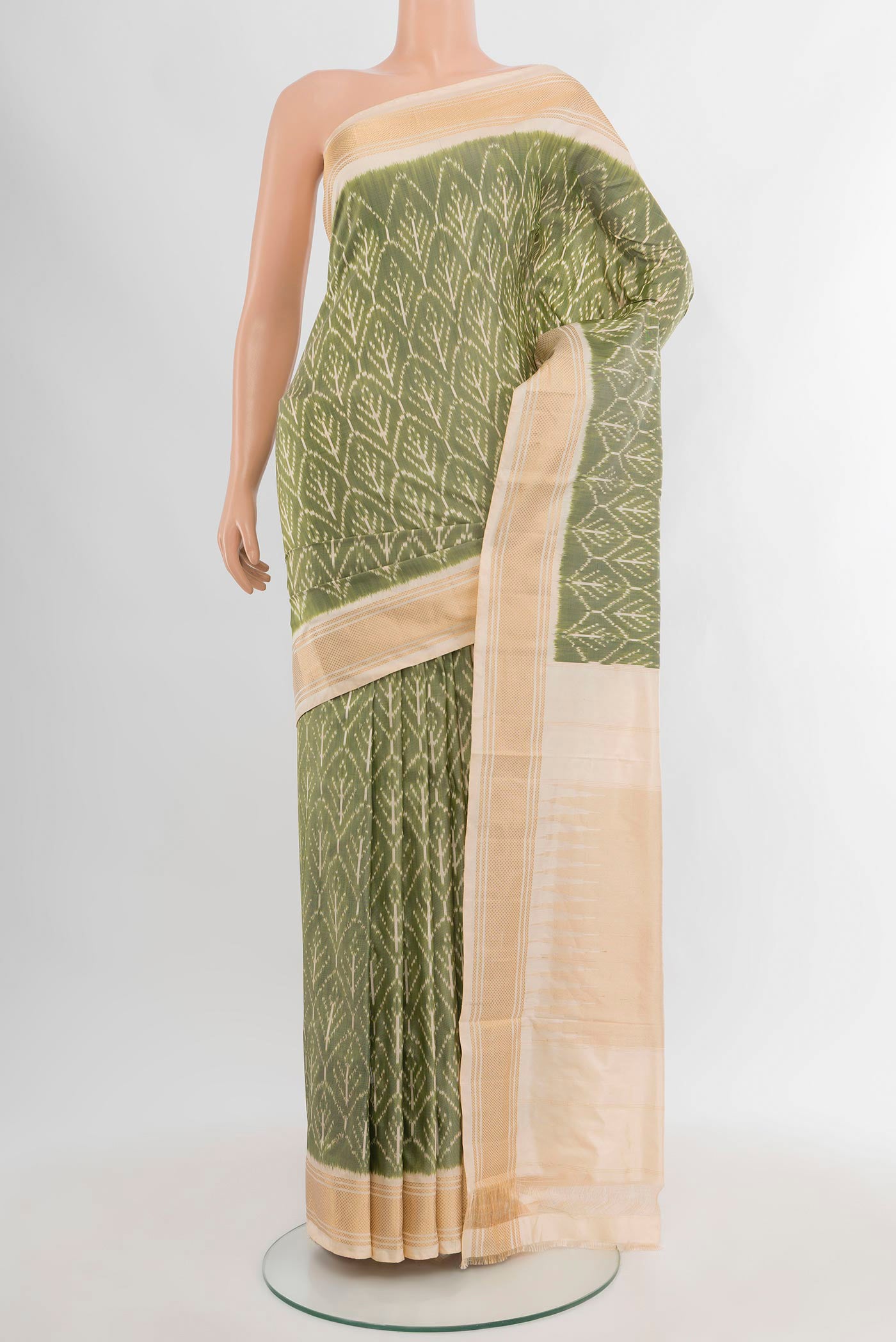 Sage Green Pochampally Silk Saree with Pure Ikat on the body and Zari Border.  displayed on a mannequin