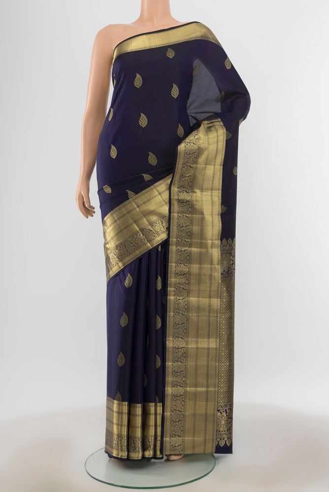 Pure Silk Pure Zari Navy Blue Kanjivaram Saree with Zari Butta on the body and Silk Border.  displayed on a mannequin