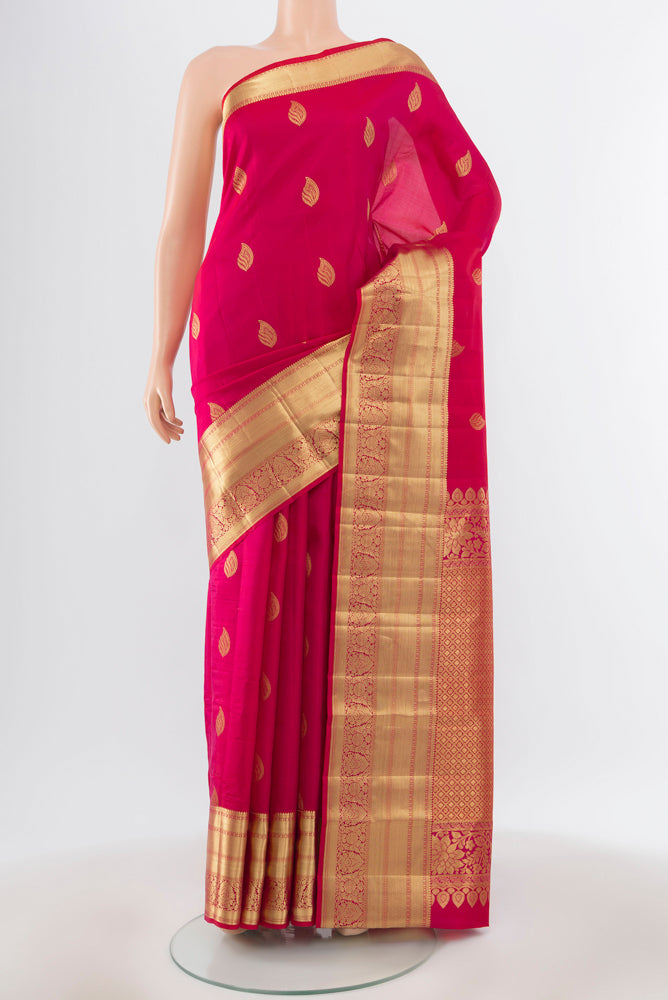 Pure Silk Pure Zari Dark Pink Kanjivaram Saree with Zari Butta on the body and Silk Border.  displayed on a mannequin