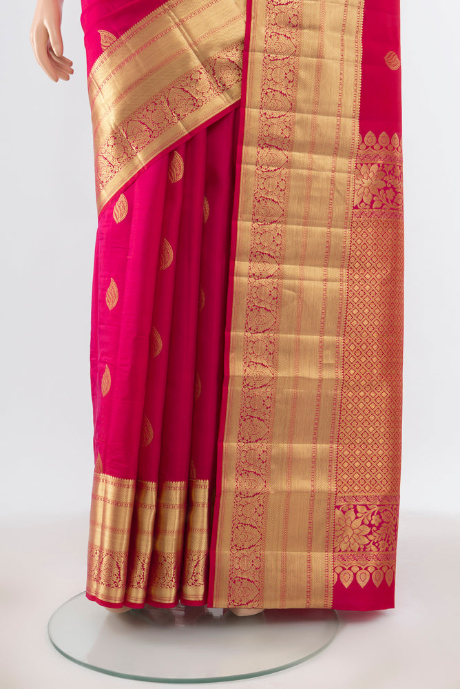 Pleats and pallu of Pure Silk Pure Zari Dark Pink Kanjivaram Saree with Zari Butta on the body and Silk Border. 