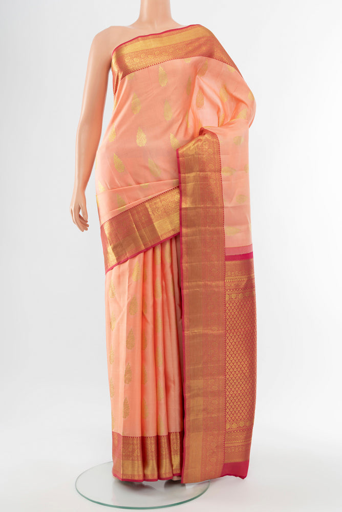 Rose Gold Kanjivaram Silk Saree with Zari Butta on the body and Silk Border.  displayed on a mannequin