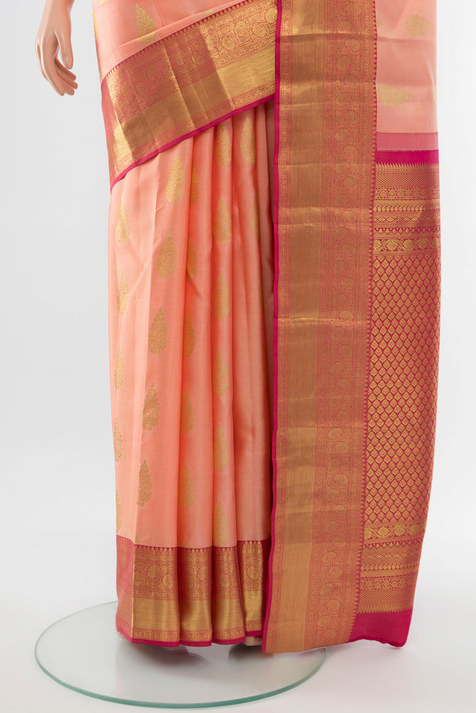 Pleats and pallu of Rose Gold Kanjivaram Silk Saree with Zari Butta on the body and Silk Border. 
