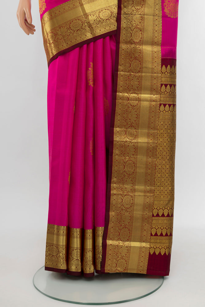 Pleats and pallu of Dark Pink Kanchipuram Silk Saree with Zari Butta on the body and Silk Border. 