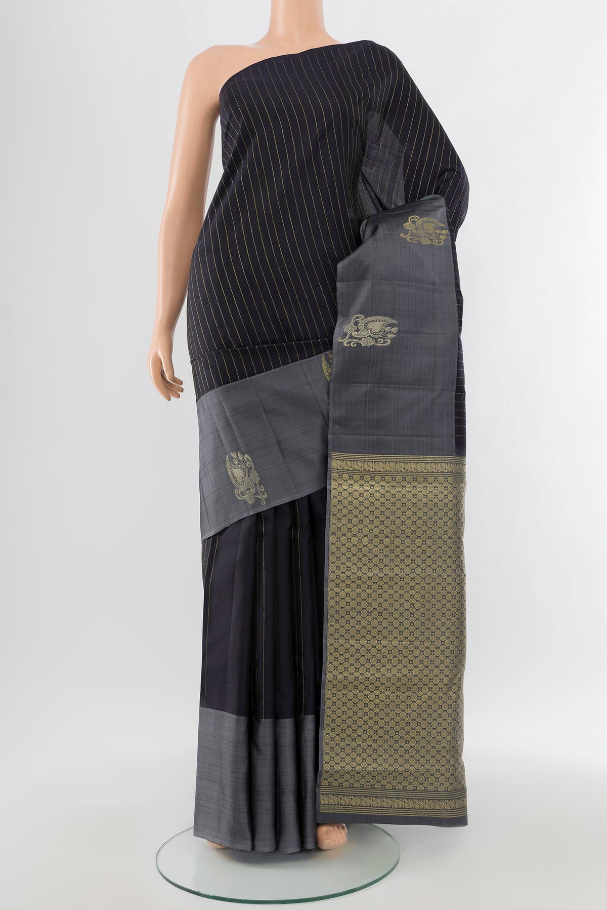 Pure Silk Pure Zari Black Kanchipuram Saree with Zari Butta on the body and Silk Border.  displayed on a mannequin
