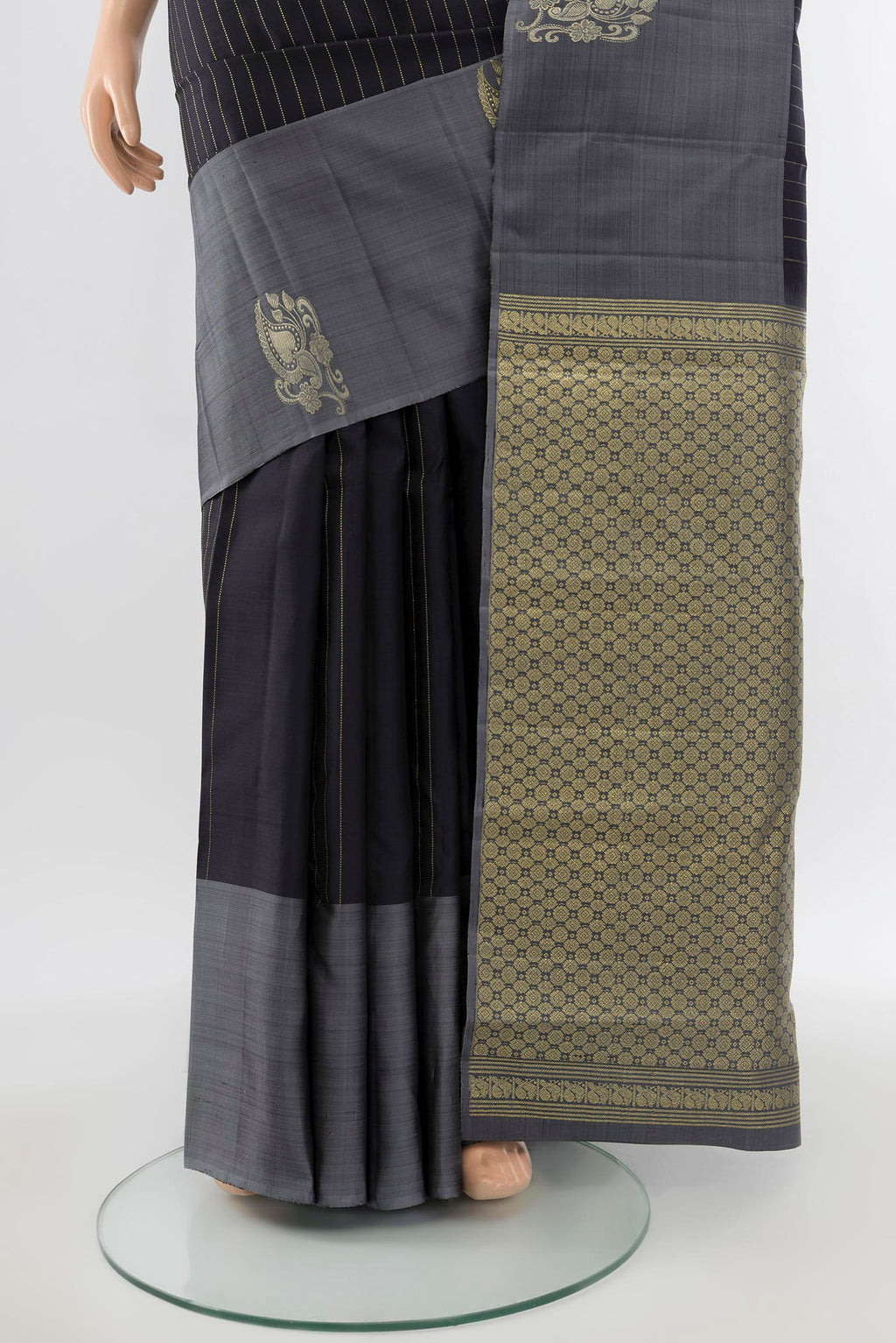 Pleats and pallu of Pure Silk Pure Zari Black Kanchipuram Saree with Zari Butta on the body and Silk Border. 