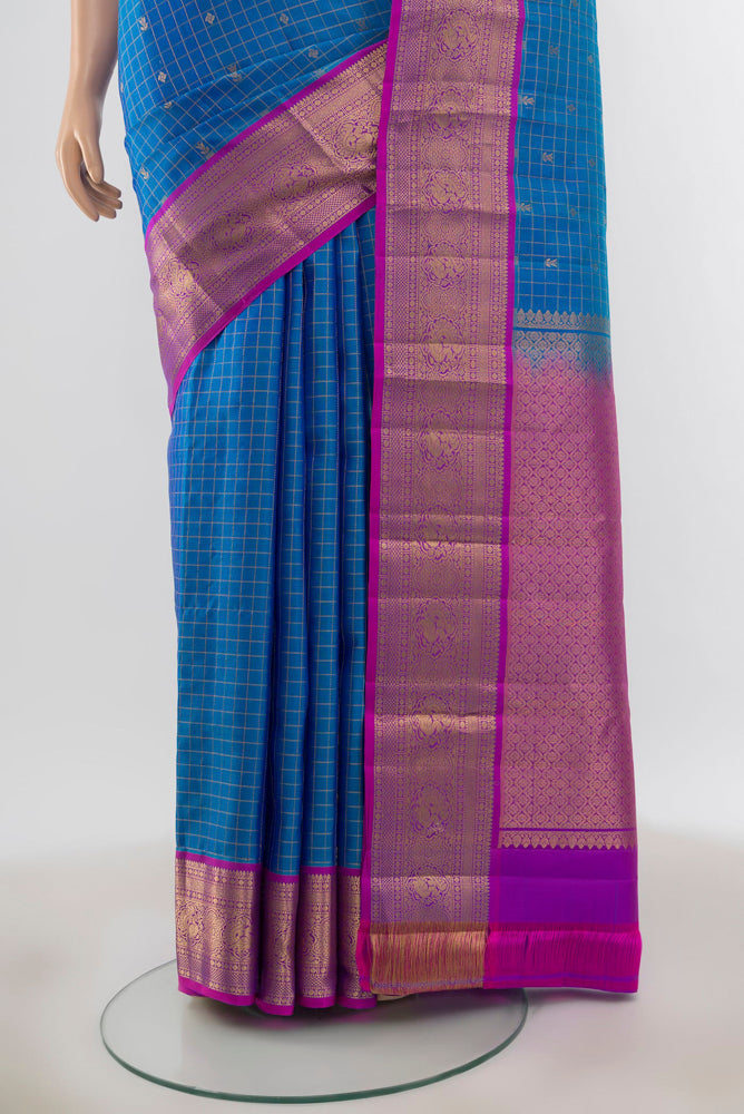 Pleats and pallu of Pure Silk Pure Zari Light Blue Kanchipuram Saree with Zari Butta on the body and Silk Border. 