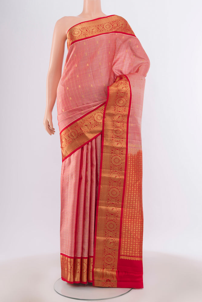 Peach Kanchipuram Silk Saree with Zari Butta on the body and Silk Border.  displayed on a mannequin