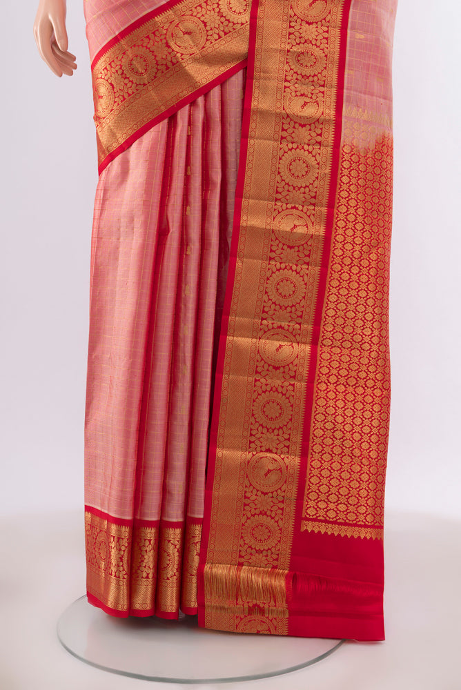 Pleats and pallu of Peach Kanchipuram Silk Saree with Zari Butta on the body and Silk Border. 