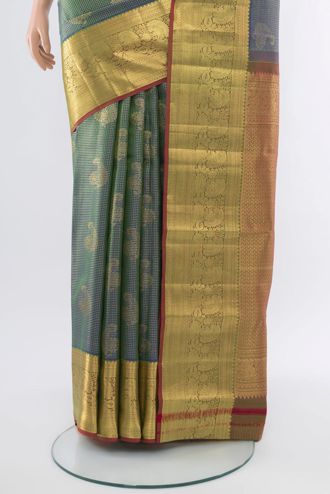 Pleats and pallu of Golden Kanchipuram Silk Saree with Zari Butta on the body and Silk Border. 
