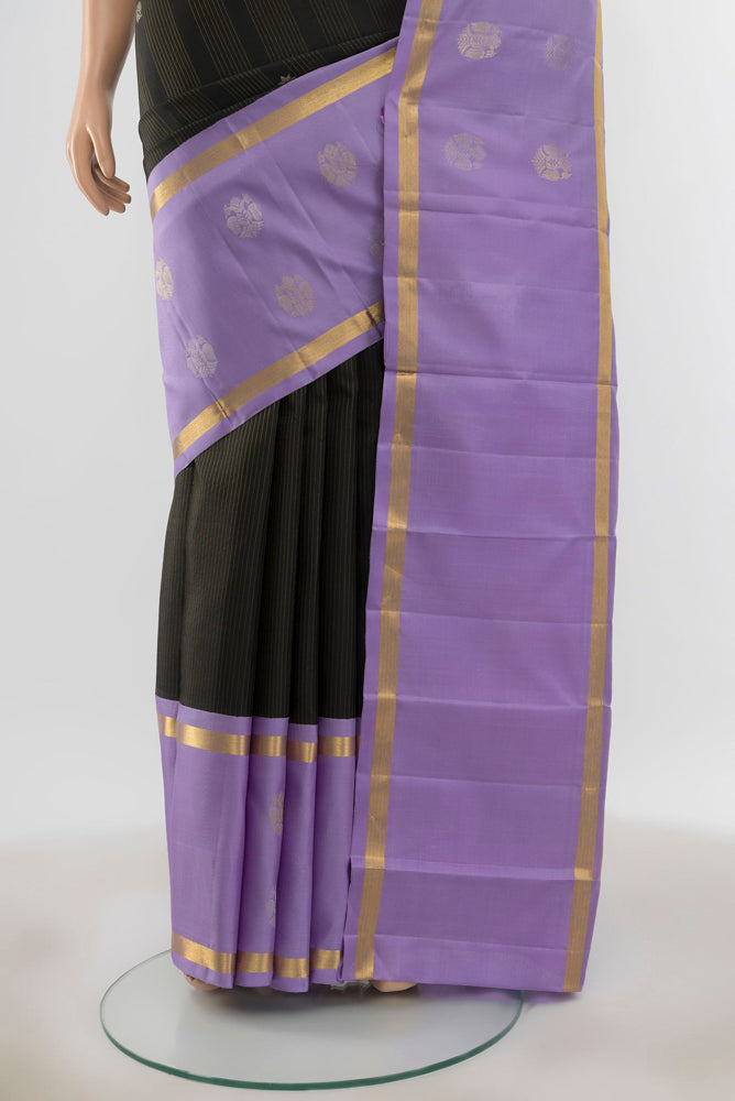 Pleats and pallu of Pure Silk Pure Zari Black Kanjivaram Saree with Zari Butta on the body and Silk Border. 