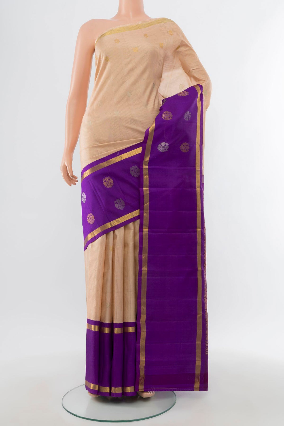 Cream Kanjivaram Silk Saree with Zari Butta on the body and Fancy Border.  displayed on a mannequin