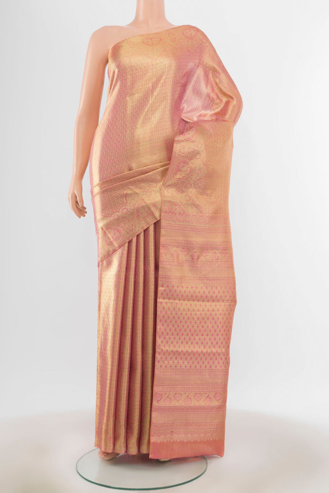 Golden Peach Kanjivaram Silk Saree with Zari Butta on the body and Silk Border.  displayed on a mannequin
