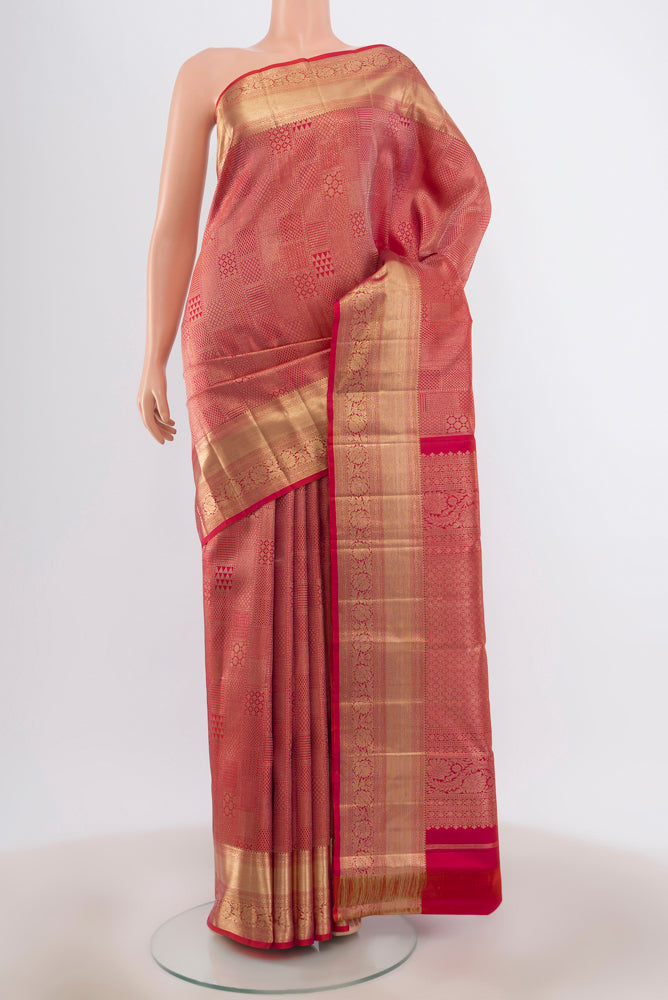 Golden Peach Kanjivaram Silk Saree with Zari Butta on the body and Silk Border.  displayed on a mannequin