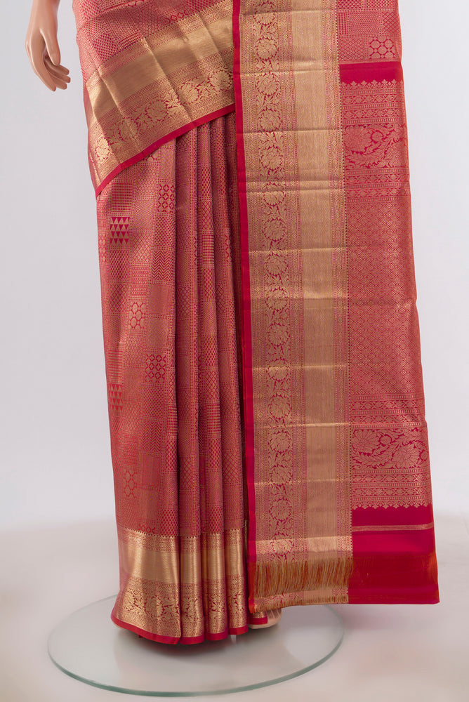 Pleats and pallu of Golden Peach Kanjivaram Silk Saree with Zari Butta on the body and Silk Border. 