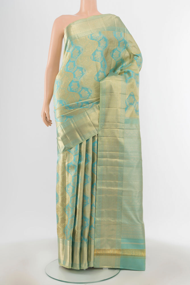 Golden Kanjivaram Silk Saree with Zari Butta on the body and Silk Border.  displayed on a mannequin