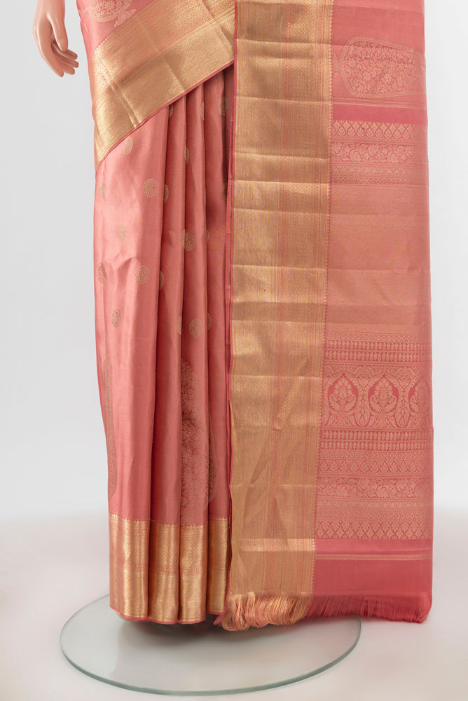 Pleats and pallu of Rose pink Kanjivaram Silk Saree with Zari Butta on the body and Silk Border. 