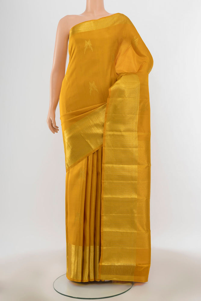 Pure Silk Pure Zari Yellow Kanjivaram Saree with Zari Butta on the body and Silk Border.  displayed on a mannequin