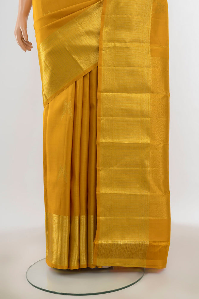Pleats and pallu of Pure Silk Pure Zari Yellow Kanjivaram Saree with Zari Butta on the body and Silk Border. 