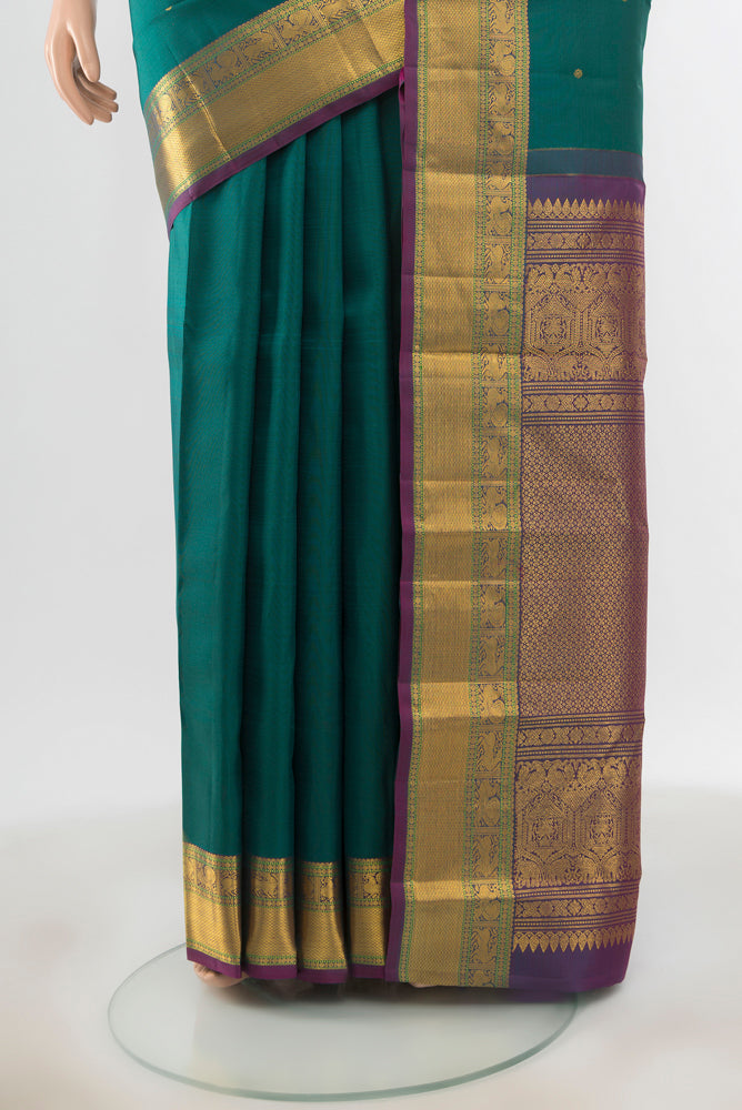 Pleats and pallu of Pure Silk Pure Zari Peacock Blue Kanjivaram Saree with Zari Butta on the body and Silk Border. 