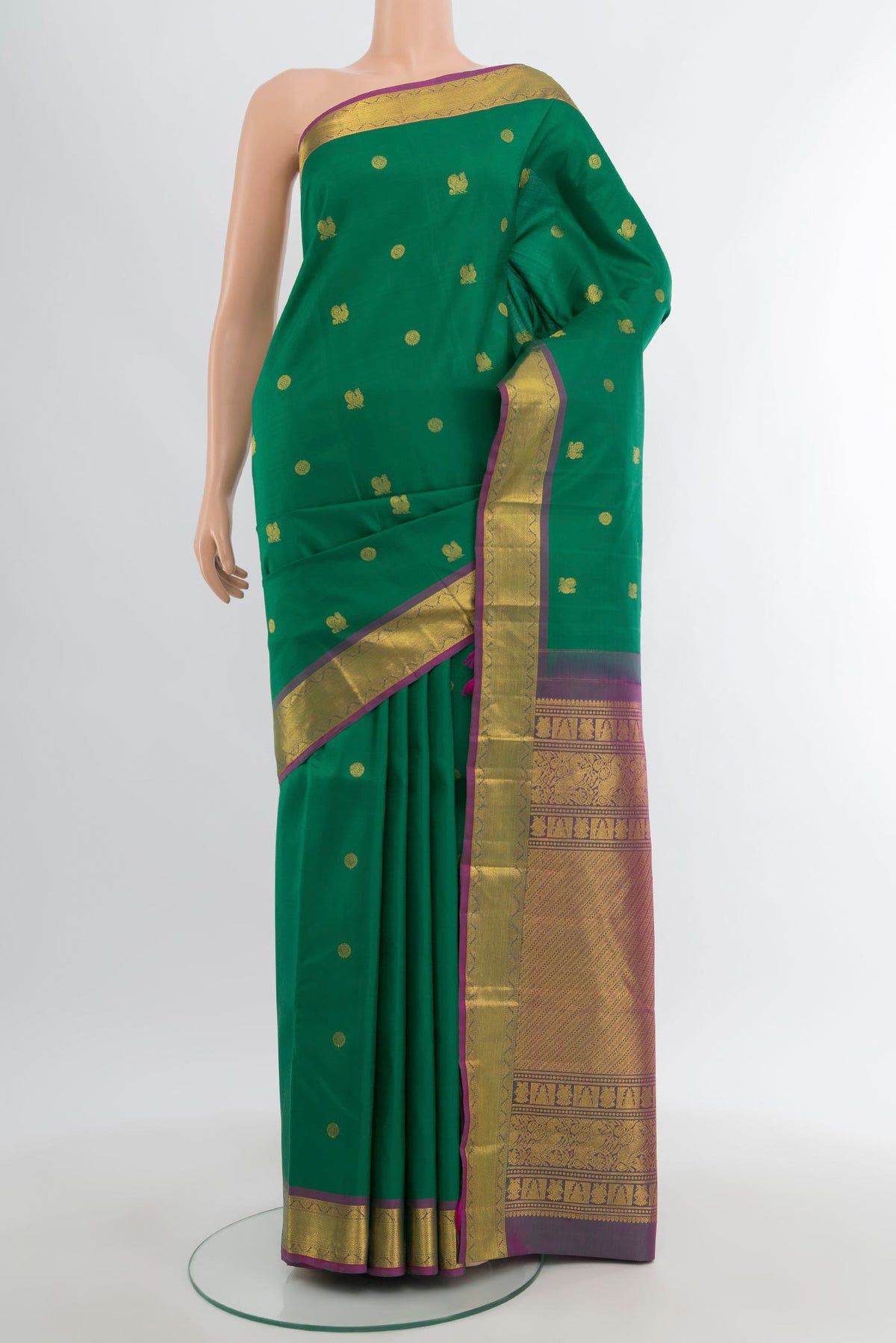 Green Kanjivaram Silk Saree with Zari Butta on the body and Zari Border.  displayed on a mannequin