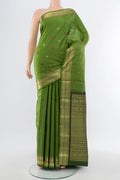 Light Green Kanjivaram Silk Saree with Zari Butta on the body and Silk Border.  displayed on a mannequin