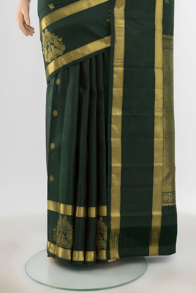 Pleats and pallu of Pure Silk Pure Zari Bottle Green Kanjivaram Saree with Zari Butta on the body and Silk Border. 